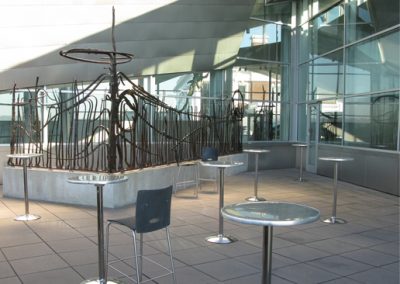 The balcony of the Hunter Museum with tall tables and an iron sculpture.
