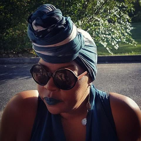 Close up of Erika Roberts wearing sunglasses and a head wrap.