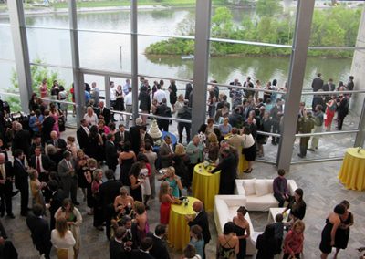 Aerial shot of a crowd of people mingling in the Hunter Museum lobby and on the terrace.