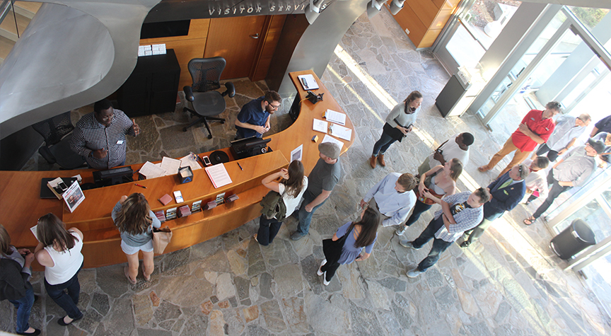 An aerial shot of people entering the Hunter Museum lobby approaching the front desk.