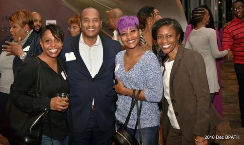 People smiling for the camera at a Black Professionals event.
