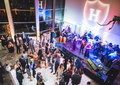 Aerial view of a wedding reception in the Hunter Museum lobby. The dance floor full of guests and band are pictured.